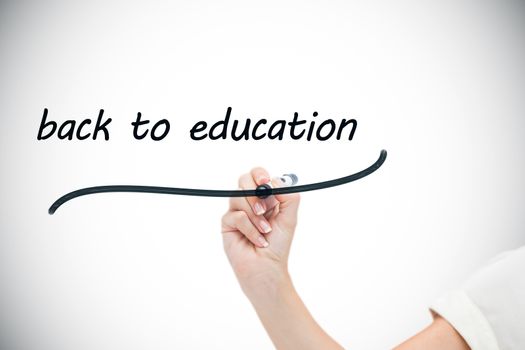 Businesswoman writing the words back to education against white background with vignette