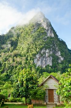 Front home in the morning surrounded by forests and mountains