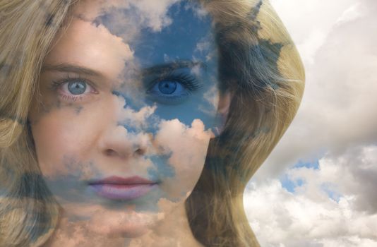 Serious blonde natural beauty against blue sky with white clouds