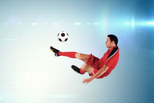 Football player in red kicking against technical screen with pixels 