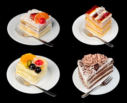 Cakes on plates with forks isolated on black