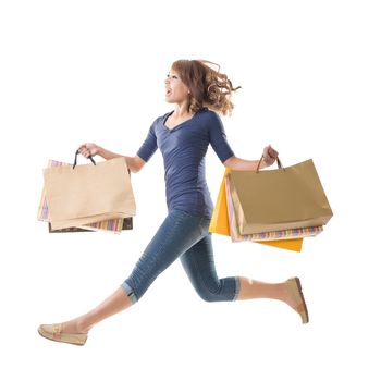 Asian shopping woman jumping, isolated on white.