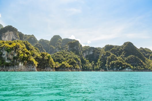 High mountain range above the green lake at Ratchapapha dam in Khao Sok National Park, Surat Thani province, Guilin of Thailand.