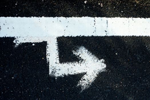 White traffic lines painted on the road surface by hand.