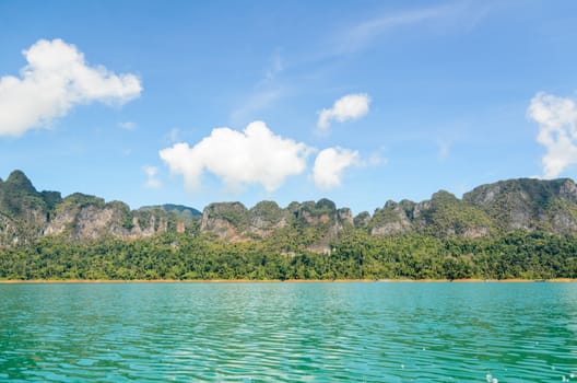 High mountain range above the green lake at Ratchapapha dam in Khao Sok National Park, Surat Thani province, Guilin of Thailand.