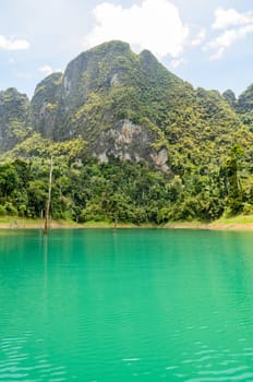 High mountain range above the green lake at Ratchapapha dam in Khao Sok National Park, Surat Thani province, Guilin of Thailand.