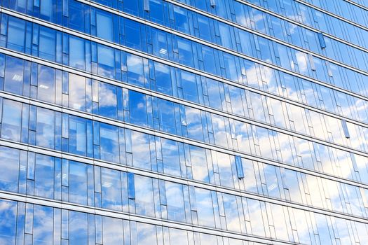 glass wall of office building,with reflection of clouds