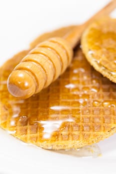 A hearty breakfast of golden brown waffles covered in honey