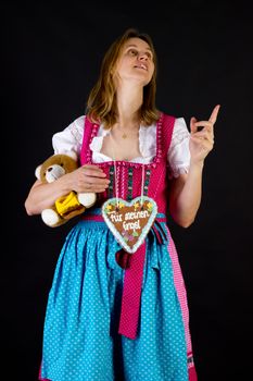 Woman in dirndl pointing at something