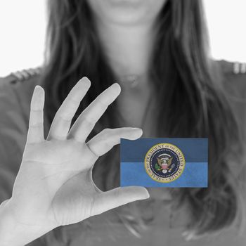 Woman showing a business card, Presidential Seal