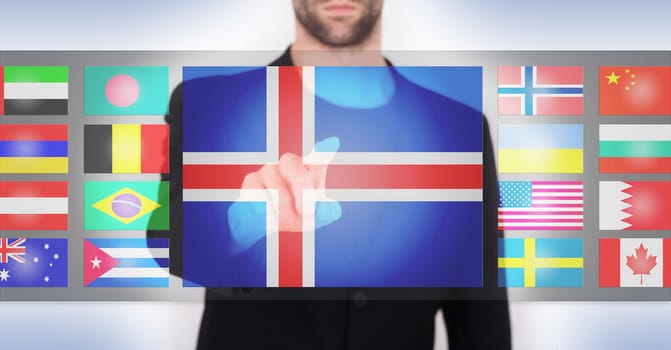 Hand pushing on a touch screen interface, choosing language or country, Iceland