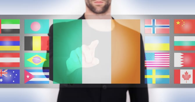 Hand pushing on a touch screen interface, choosing language or country, Ireland