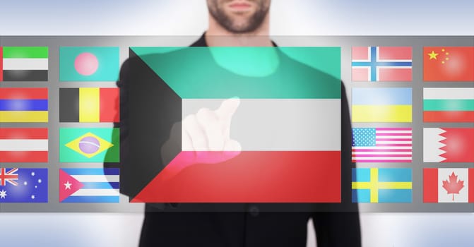 Hand pushing on a touch screen interface, choosing language or country, Kuwait
