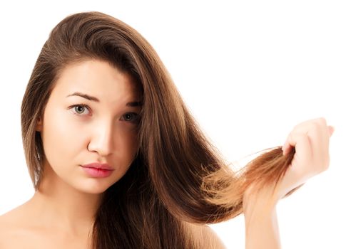 woman is not happy with her fragile hair, white background, copyspace