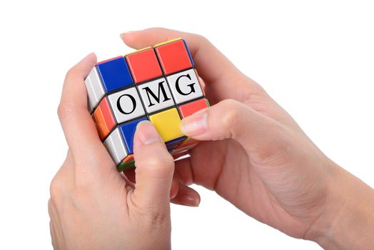 woman hand playing Square puzzle to be OMG the well known expression or abbreviation for Oh My God