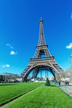 Spectacular view of Tour Eiffel structure on a beautiful sunny day. Eiffel Tower under blue sky, Paris.