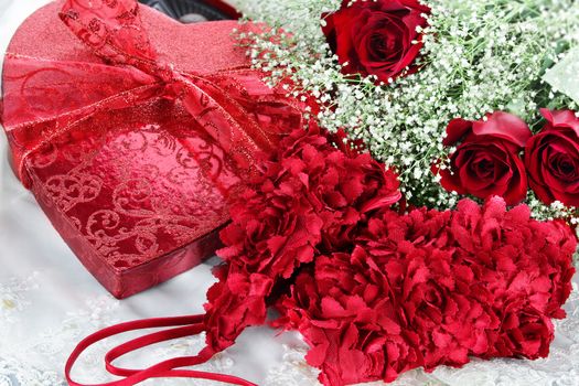 Lingerie with heart shaped box of Valentines Day chocolates and beautiful long stem red roses.