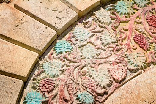 Fragment of the ancient gate decorated with the image of grapes, separating old part of the city of Retimno from the modern. Island of Crete, Greece.