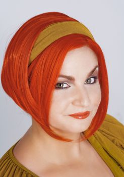 Portrait of a Young Woman in Red Wig - Isolated on Gray