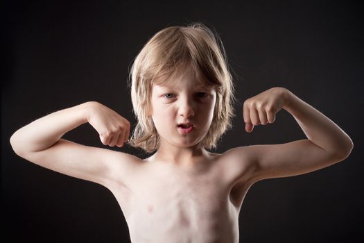 Boy with Blond Hair Showing his Muscles