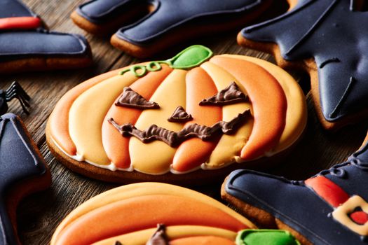 Halloween homemade gingerbread cookies over wooden table