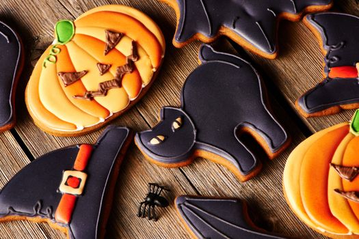 Halloween homemade gingerbread cookies over wooden table