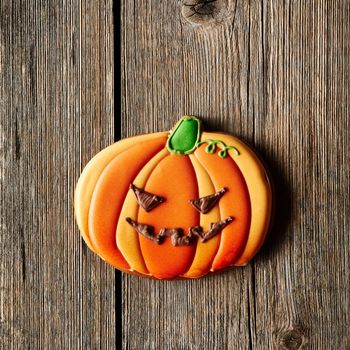 Halloween homemade gingerbread cookie over wooden table