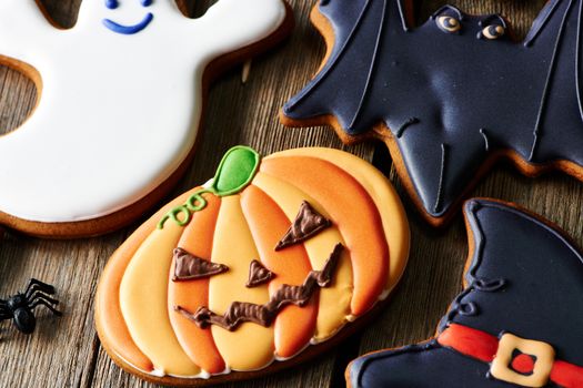 Halloween homemade gingerbread cookies over wooden table