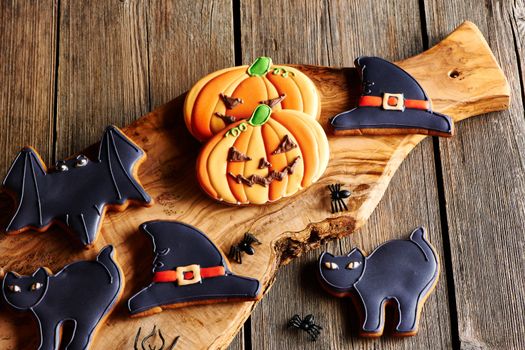 Halloween homemade gingerbread cookies over wooden table