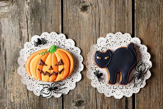 Halloween homemade gingerbread cookies over wooden table