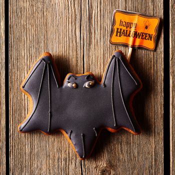 Halloween homemade gingerbread cookie over wooden table