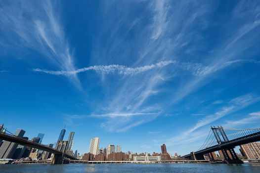 Manhattan skyline view from Brooklyn between Brooklyn Bridge and Manhattan Bridge in New York City