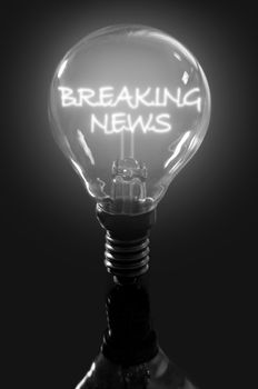 Lit bulb with breaking news illuminated text 