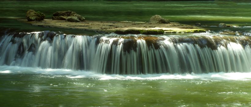 The small waterfall and rocks in National Park, Thailand.