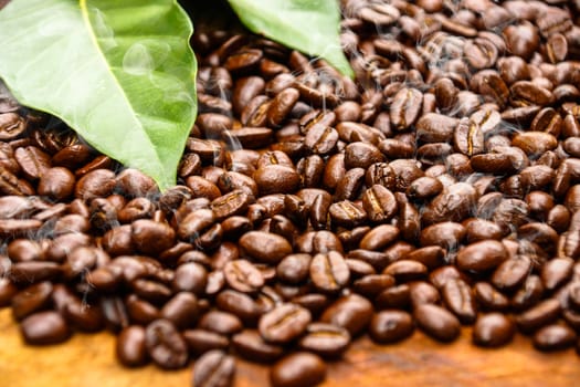 Coffee beans on the wooden background.