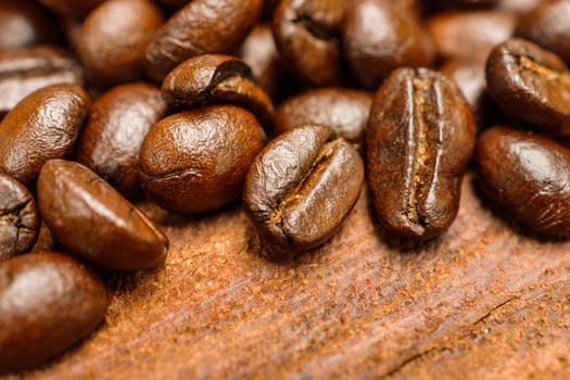 Coffee beans on the wooden background.