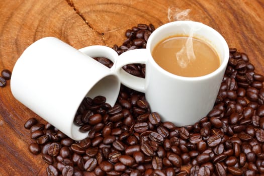 Coffee and beans on the wooden background.