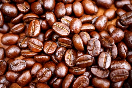 Coffee beans on the wooden background.