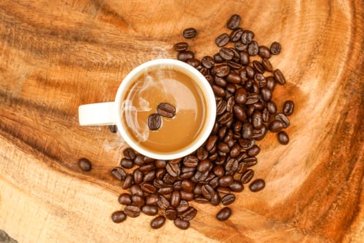 Coffee and beans on the wooden background.