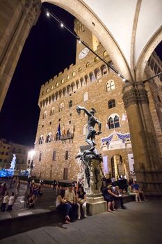 Pisa, Italy - August 10, 2013: Tourists arround Perseus holding head of Medusa, bronze statue by Benvenuto Cellini in Loggia de Lanzi, Piazza della Signoria, Florence, Italy