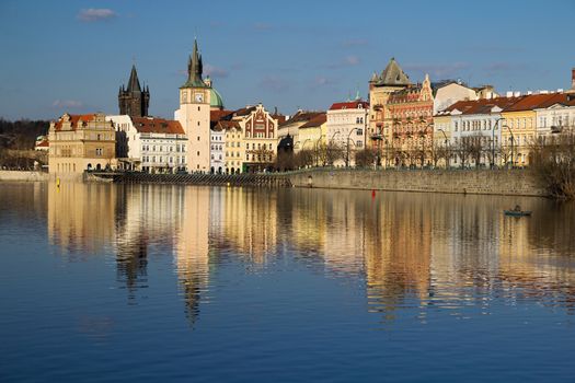 Photo shows various historical houses, Vltava river, bridges and other architectural details.