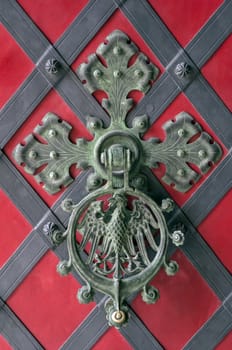 Close up view of an ornamental castle door knocker.