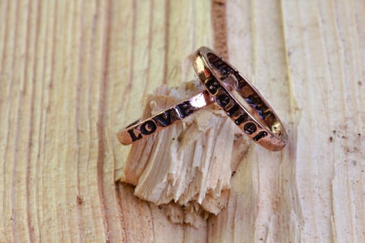 Photo shows details of rings on the wooden background.