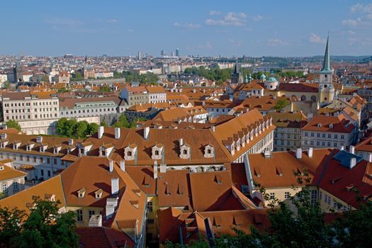 Photo shows general view onto city red roof houses.