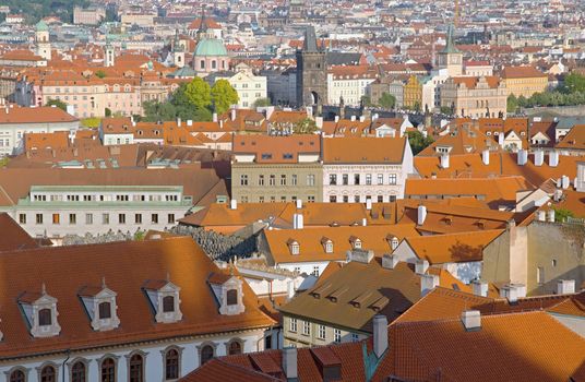 Photo shows general view onto city red roof houses.