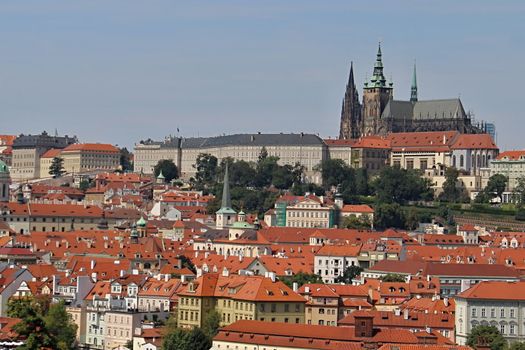 Photo shows details of Prague red roofs and old houses.