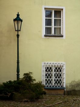 Photo shows detail of street lamp with its historical surroundings.