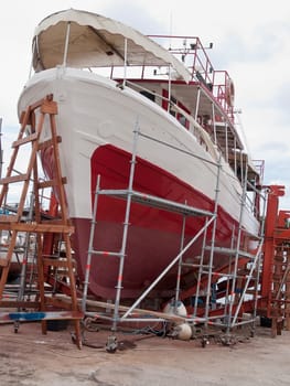 old fishing boat under repair in dry dock