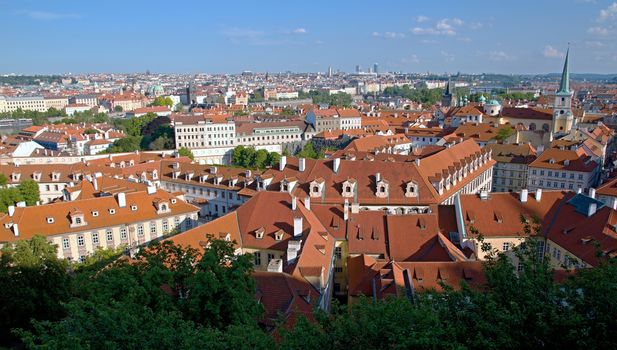 Photo shows general view onto city red roof houses.