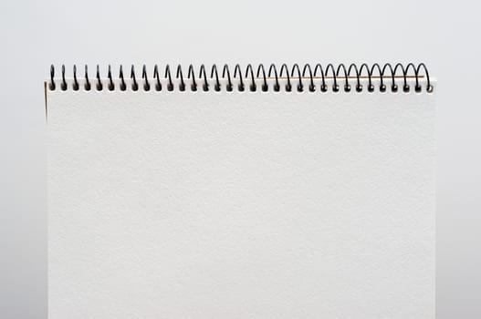 close up of a blank white notebook on white background